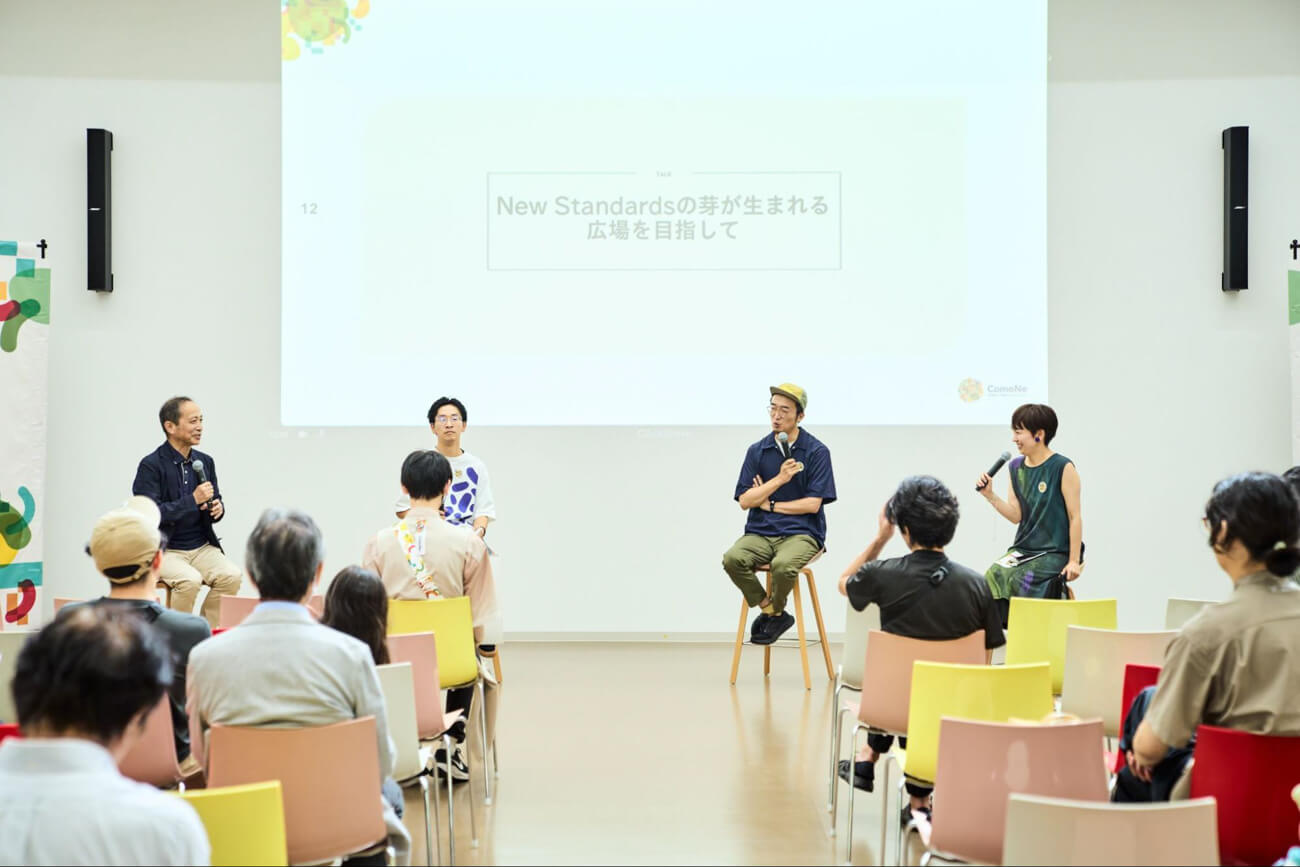 登壇者４人がイベント会場でトークを行なっている様子。来場者は席に着いて見守っている